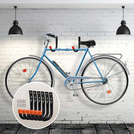 velo bleu suspendu sur mur de briques blanche horizontalement avec deux support mural pour velo