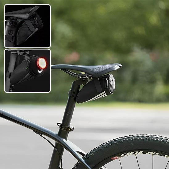 sacoche de selle sur siege velo noir devant verdure